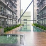 Modern studio apartment interior at Green Residences on Taft Avenue, Manila, featuring a comfortable bed, a smart TV with Netflix, and city views.