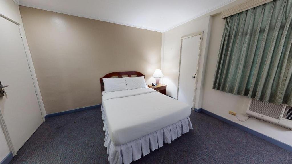 Cozy and elegant interior room setup at Adriatico Arms Hotel in Malate, Manila, featuring classic Filipino-Spanish heritage design and modern amenities.