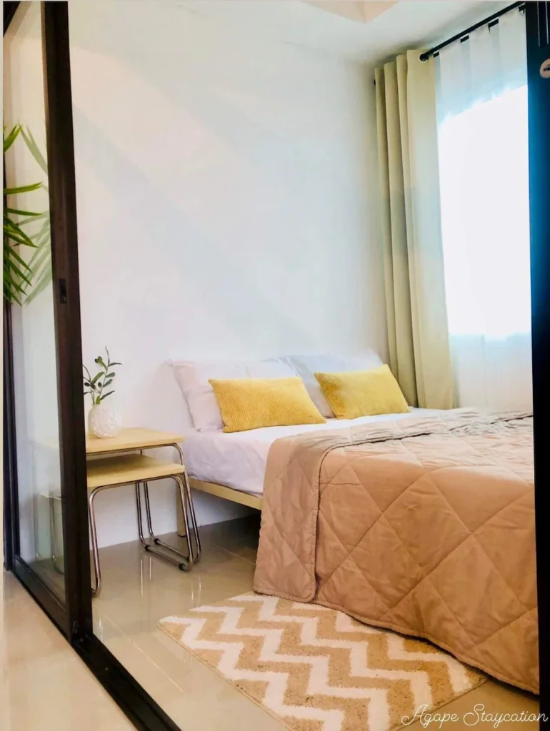 Cozy and modern interior room design of Room 92 at Agape Staycation in Manila Philippines featuring stylish decor and comfortable bedding.