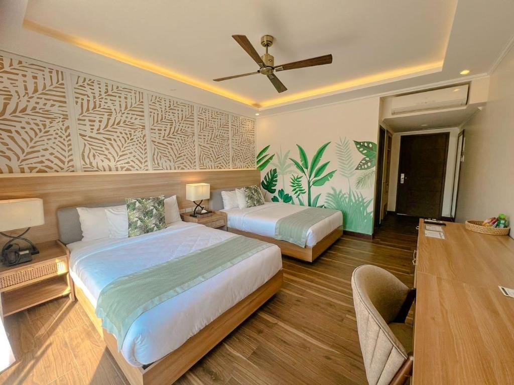 Modern luxury bedroom at Aureo Resort in La Union, Philippines, featuring a private balcony overlooking the beach and ocean.