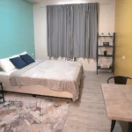 Stylish and modern studio apartment room at The CityFlats Sacred Heart in Makati, Manila, Philippines, featuring cozy bedding and urban decor.