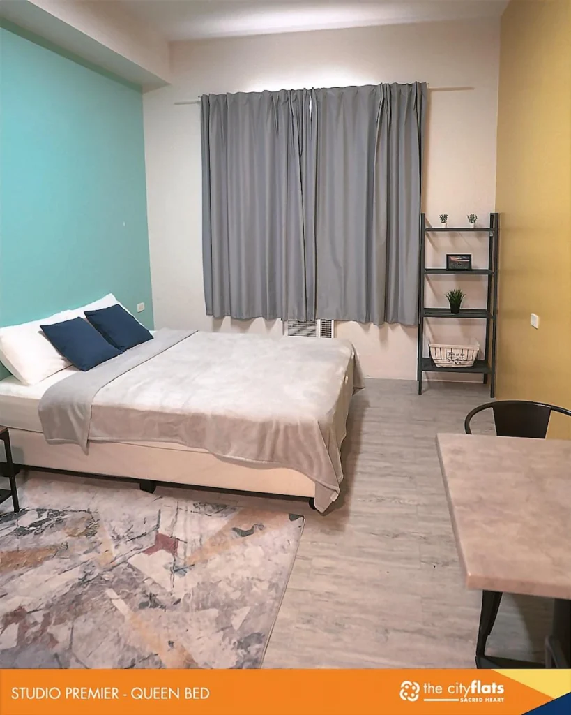 Stylish and modern studio apartment room at The CityFlats Sacred Heart in Makati, Manila, Philippines, featuring cozy bedding and urban decor.