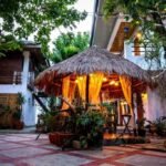 Charming rustic exterior facade of Papierus Pensionne hotel in Kalibo, Philippines, featuring cozy local architecture and a welcoming entrance for travelers.
