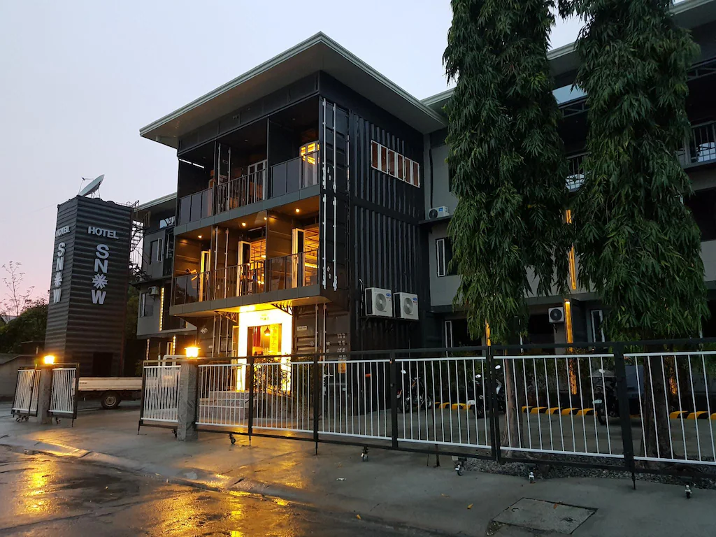 The sleek, modern exterior architecture of Hotel Snow in Angeles City near Clark, Philippines, illuminated at night with a welcoming entrance.