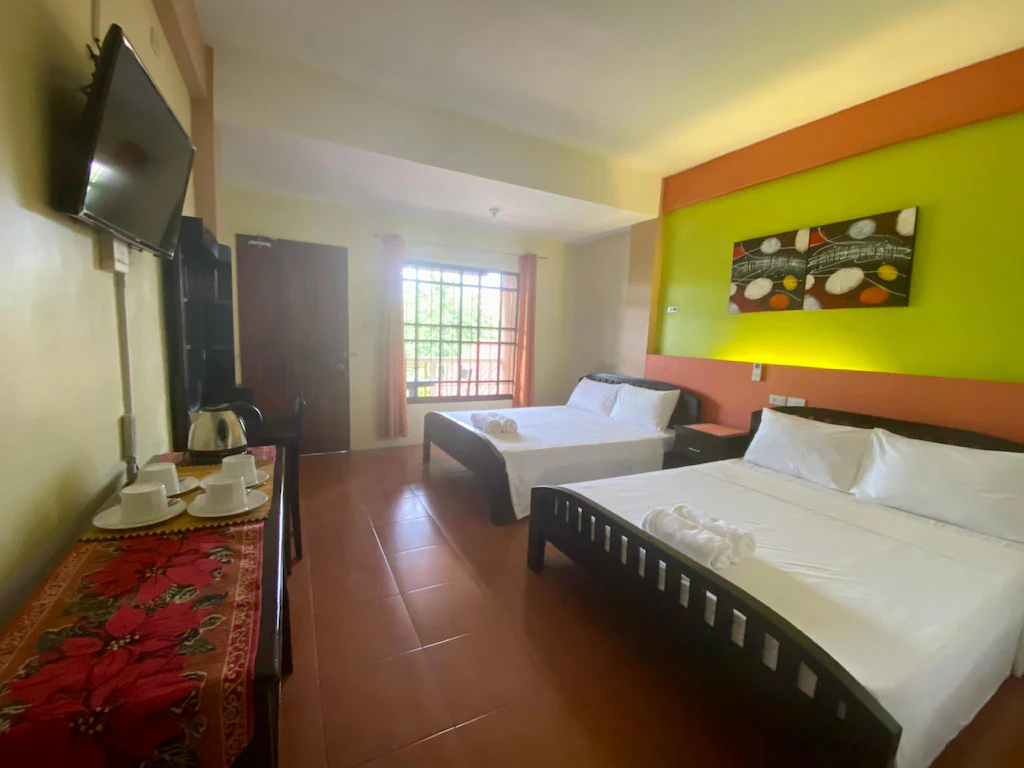 Spacious and modern interior room at Panglao Island Franzen Residences in Bohol, Philippines, featuring clean linens and cozy lighting.