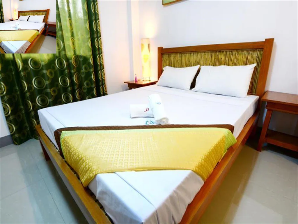 Cozy and affordable interior room at Papierus Pensionne in Kalibo, Aklan, Philippines, featuring clean bedding and local decor.