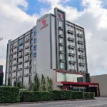 Exterior facade of Red Planet Davao hotel in Davao City, Philippines, showcasing its modern multi-story building, signature red branding, and street-level view.