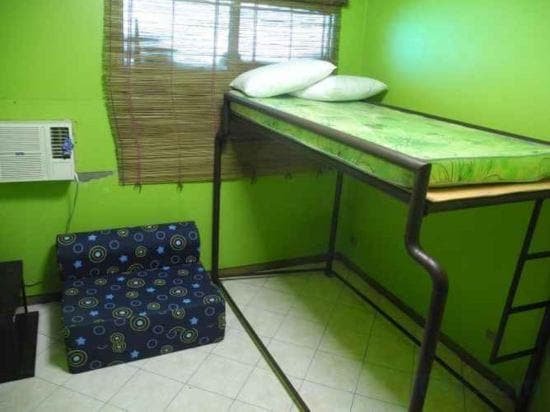 A stylish glamping tent setup and cozy hostel room interior at Room of Cebu Hostel and Glamping in Cebu, Philippines, showing comfortable bedding and ambient lighting.