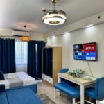 Modern coastal-inspired interior room of Sky and Cloud Place at Shore 2 Residences in Manila Philippines, featuring elegant blue and white decor, comfortable bedding, and a cozy staycation vibe near SM Mall of Asia.