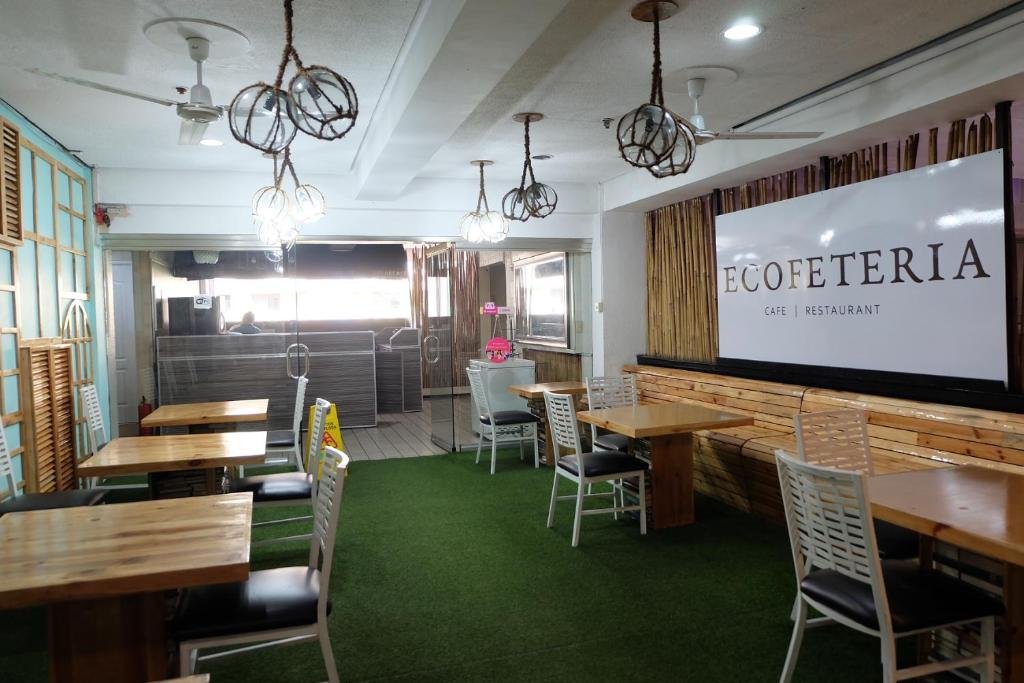 Modern and stylish restaurant interior at Spaces Hotel Makati in Manila, Philippines, featuring elegant seating, warm ambient lighting, and curated local culinary dishes on the tables.