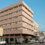 Street-level exterior view of The VIP Hotel in Cagayan de Oro, displaying a brown building facade with clear windows and a white front canopy.