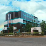Modern budget hotel room near Mactan-Cebu International Airport featuring a complimentary airport shuttle van parked outside.